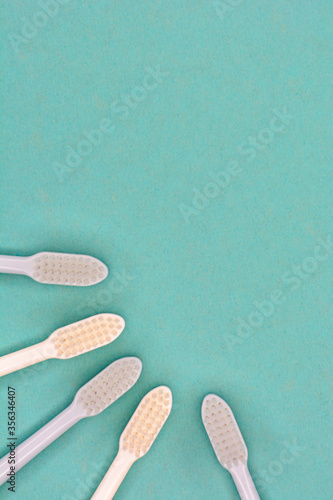 Clean toothbrushes laid out on the background for inscription text about oral...