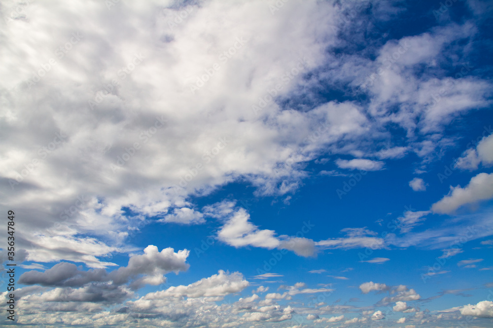 Cloudscape. Blue sky and grey clouds. Sunny day. Cumulus clouds. Cloudscape. Blue sky and grey clouds. Sunny day. Cumulus clouds.