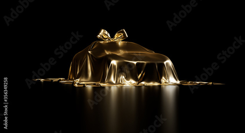 
Luxury car prize with bow-knot veiled by shiny golden cloth on a black studio background with great lighting. Expensive gift.