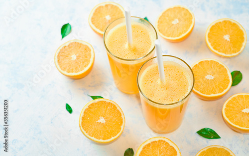 orange juice in a glass  top view  slices of oranges  straw  healthy lifestyle concept