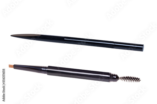 Cosmetic tools. Macro photograph of a slanted professional eyebrow pencil and brush isolated on a white background. photo