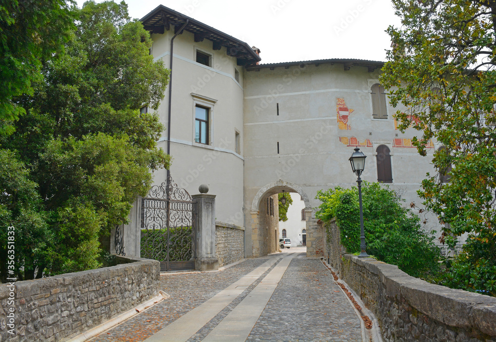 The entrance through the gate tower to courtyard of the historic Spilimbergo castle in the province of Udine, Friuli, north west Italy
