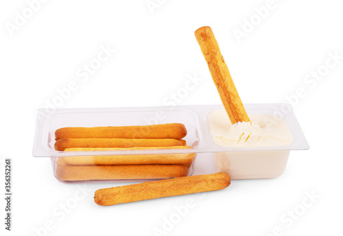 Bread sticks dipped, covered in creamy, isolated on white background