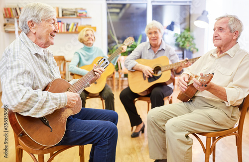 Seniors learn to play the guitar in a guitar course