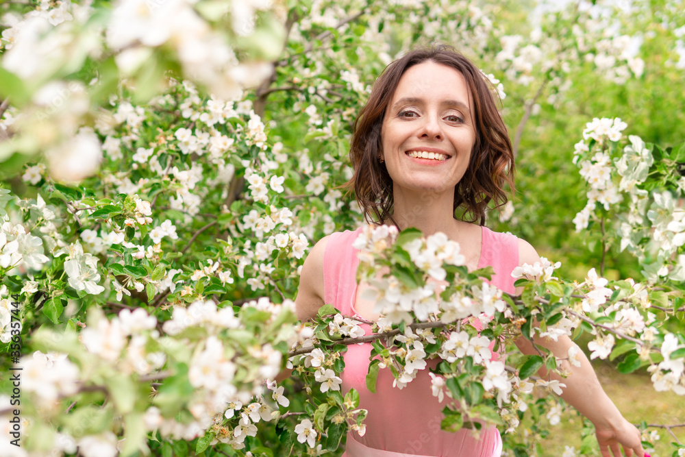 A beautiful woman walks through an Apple orchard. A beautiful woman walks through an Apple orchard.