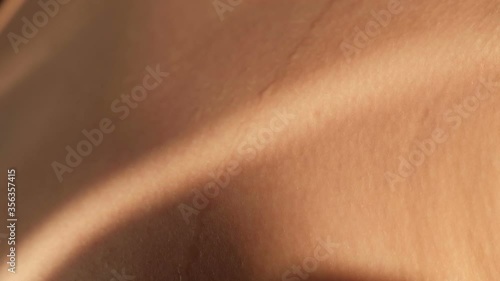 A drop of water or sweat flows over the skin, close-up