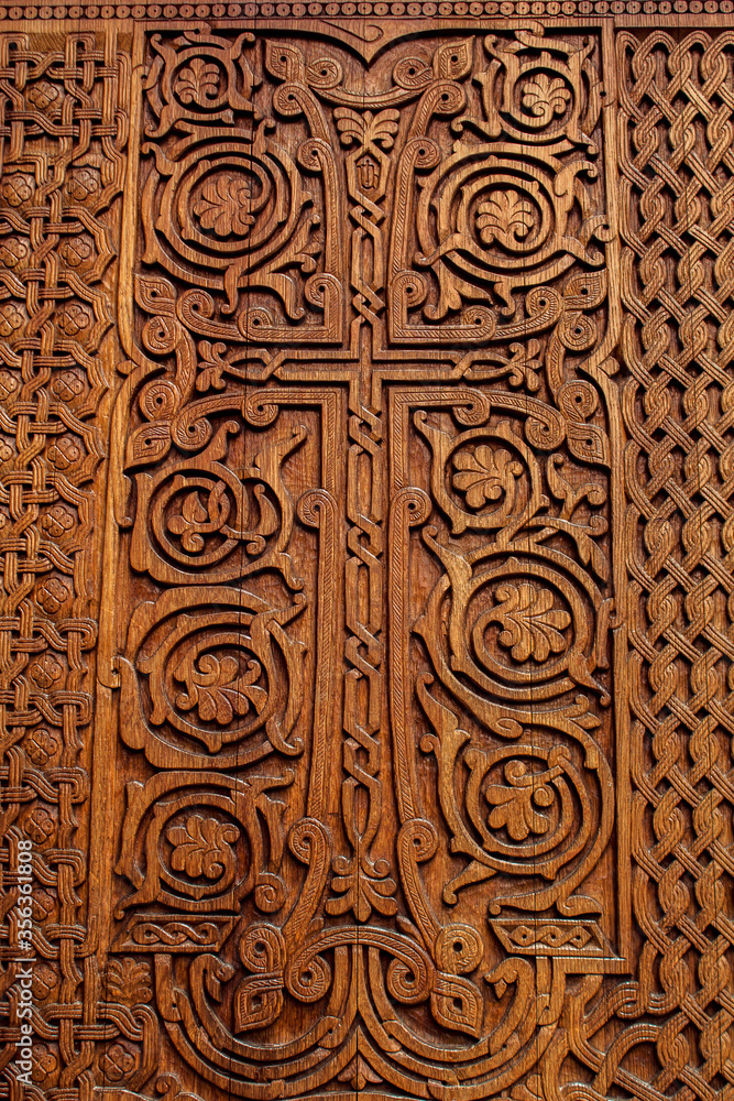 Cross on wooden door of temple, manual work