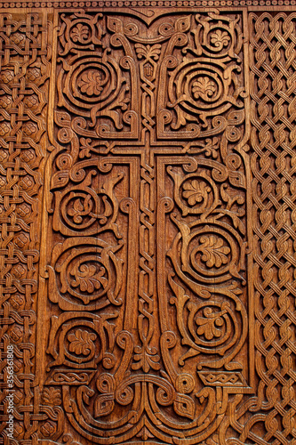Cross on wooden door of temple, manual work