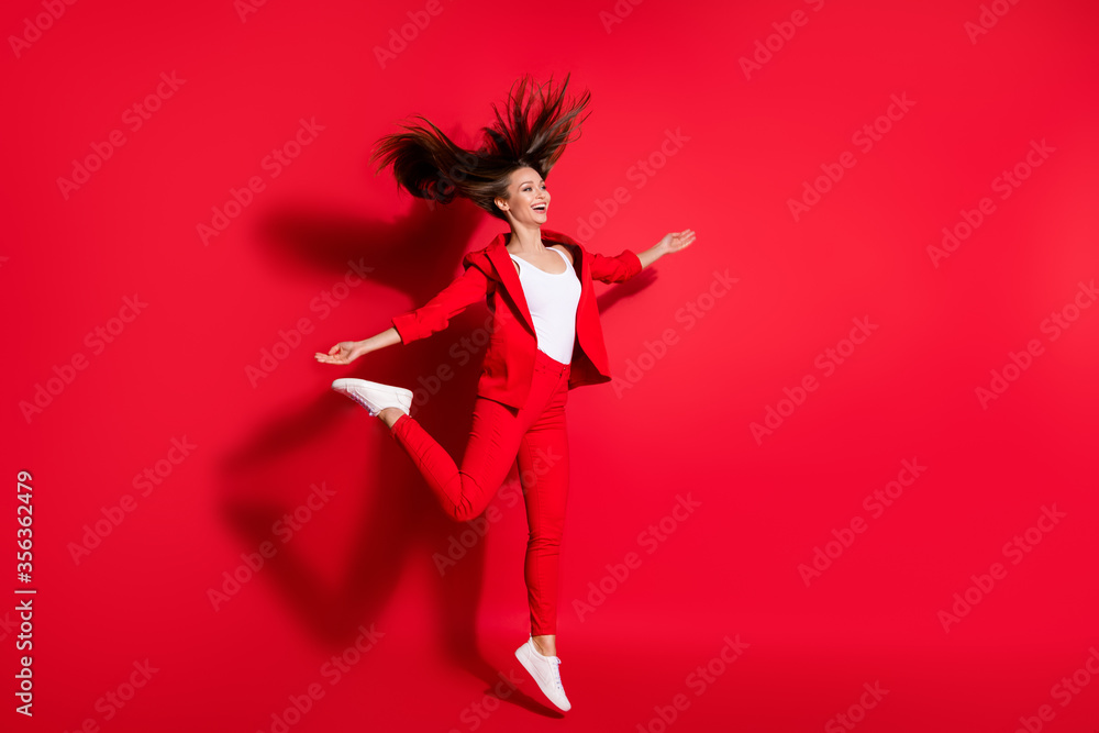 Full length profile photo of attractive worker lady having fun jumping high up good mood rejoicing vacation time wear blazer suit pants footwear isolated bright vivid red color background Full length profile photo of attractive worker lady having fun jumping high up good mood rejoicing vacation time wear blazer suit pants footwear isolated bright vivid red color background