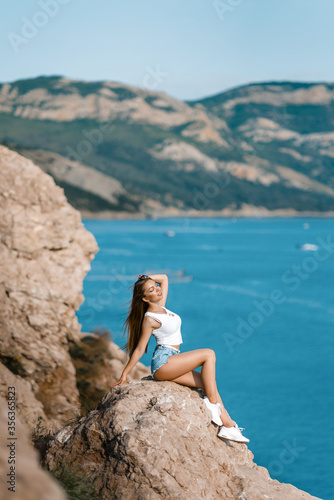 Joyful woman travel mountains. Authentic blond female relax in picturesque landscape