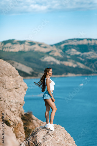 Joyful woman travel mountains. Authentic blond female relax in picturesque landscape