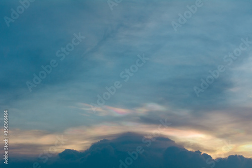 iridescent clouds in the evening before the sunset. © bankstocker