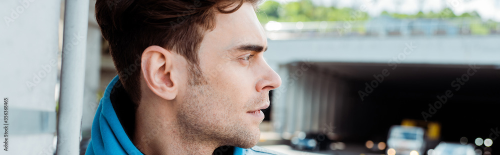Horizontal image of man looking away on urban street Horizontal image of man looking away on urban street