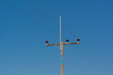 Electric pole with clear sky background.