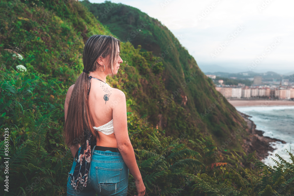 Young white girl with white shirt and jeans in the mountain.