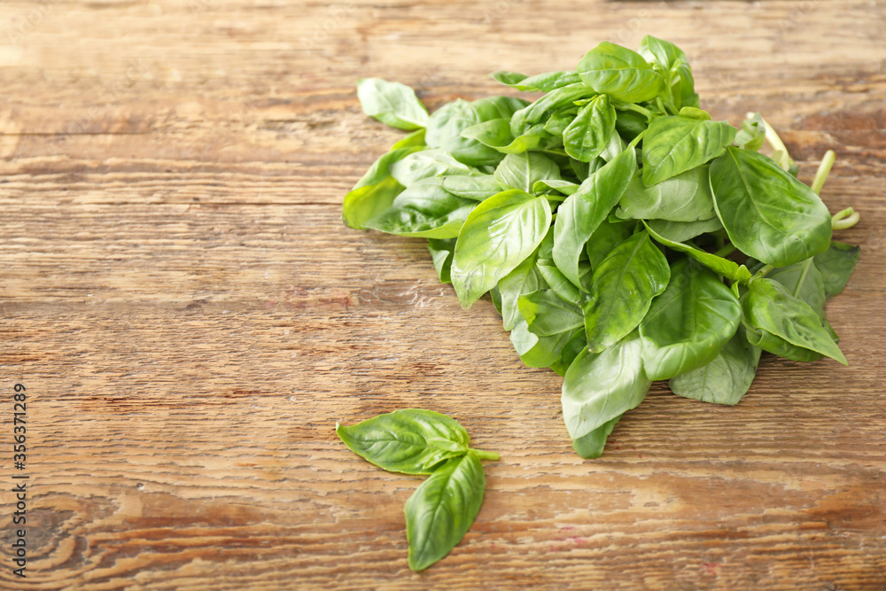 Fresh green basil on wooden background Fresh green basil on wooden background