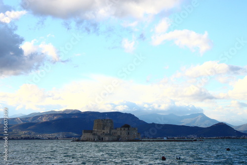 The fortress of Bourtzi at Naflion Bay, with a background of clouds photo