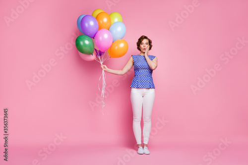 Full length body size view of her she nice-looking attractive lovely pretty slender impressed wavy-haired girl holding in hand bunch air balls isolated on pink pastel color background