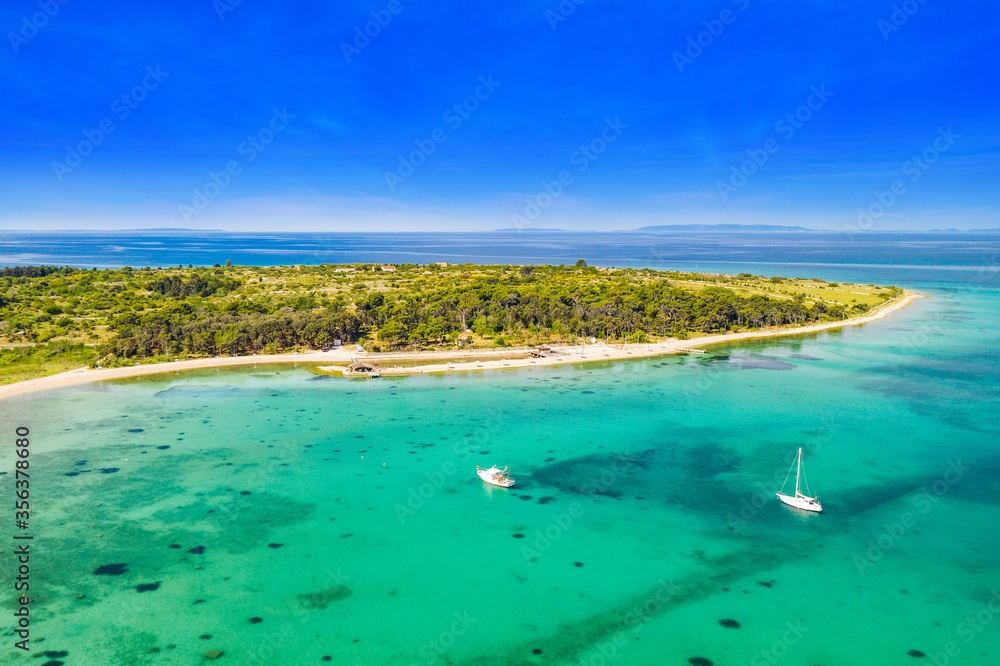 Adriatic sea paradise on the island of Pag in Croatia. Aerial seascape. Sailboats in beautiful bay.