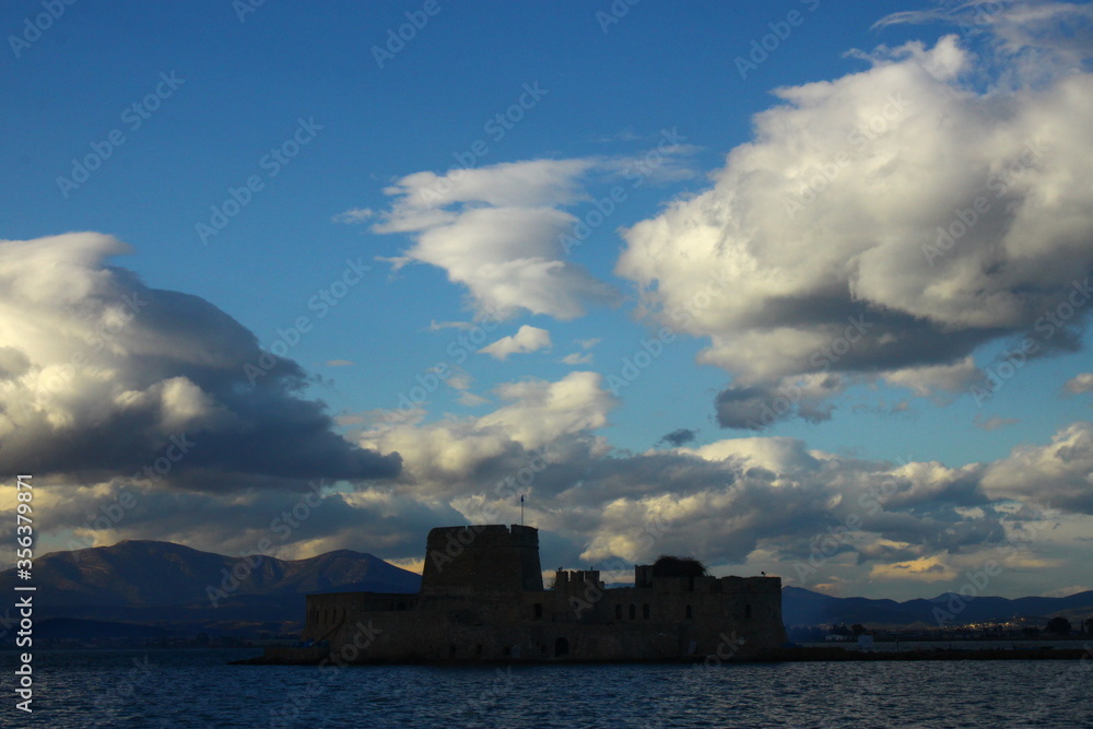 The fortress of Bourtzi at Naflion Bay, with a background of clouds