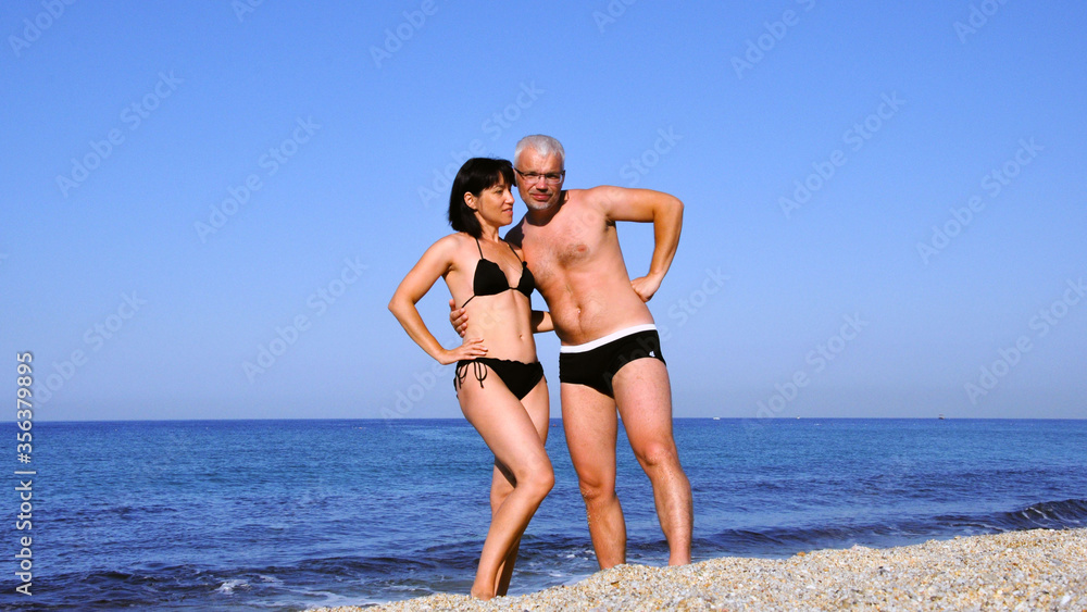 Man and woman alone on a deserted sea beach. Man and woman alone on a deserted sea beach.