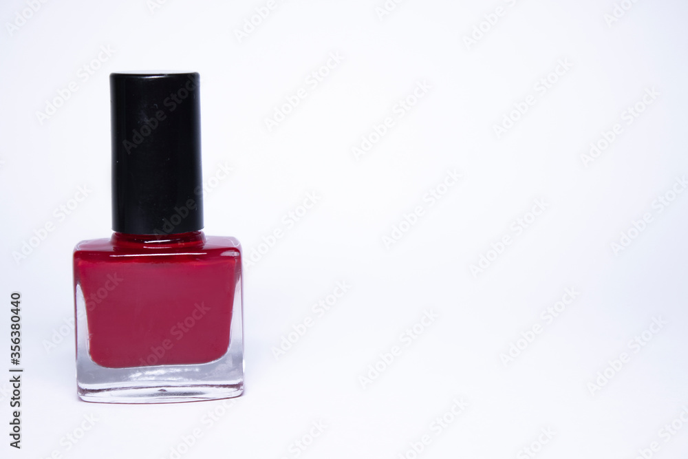 A bottle with blue nail polish on white background. nail lacquer. Nail manicure concept. Isolated, copy space. A bottle with blue nail polish on white background. nail lacquer. Nail manicure concept. Isolated, copy space.