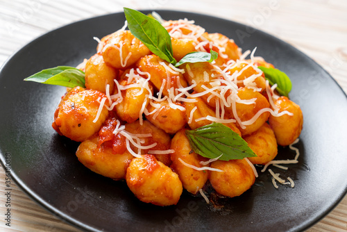 gnocchi in tomato sauce with cheese photo