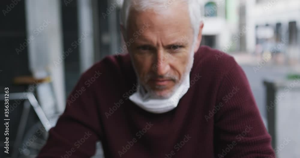 Caucasian man out and about in a coffee wearing a face mask against coronavirus Caucasian man out and about in a coffee wearing a face mask against coronavirus