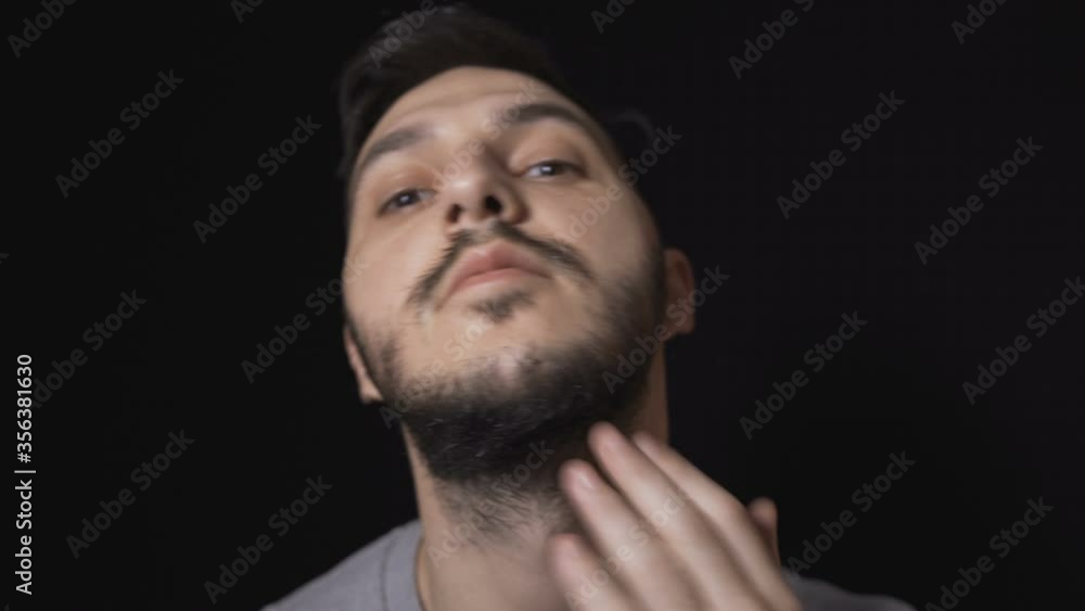 Man preparing to shave his beard with electric razor Man preparing to shave his beard with electric razor
