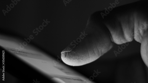 Macro of a finger on a mobile phone. © Primus_1