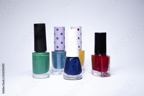 Bottles with nail polish on white background. nail lacquer. Nail manicure concept. Isolated, copy space. © OliaVesna