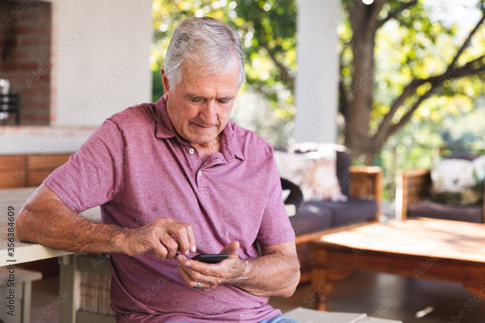 Caucasian senior using smartphone at home Caucasian senior using smartphone at home
