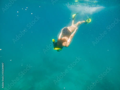 woman in snorkeling mask and flippers under water