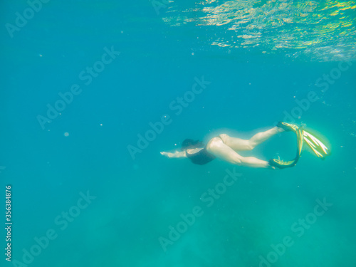 woman in snorkeling mask and flippers under water © phpetrunina14