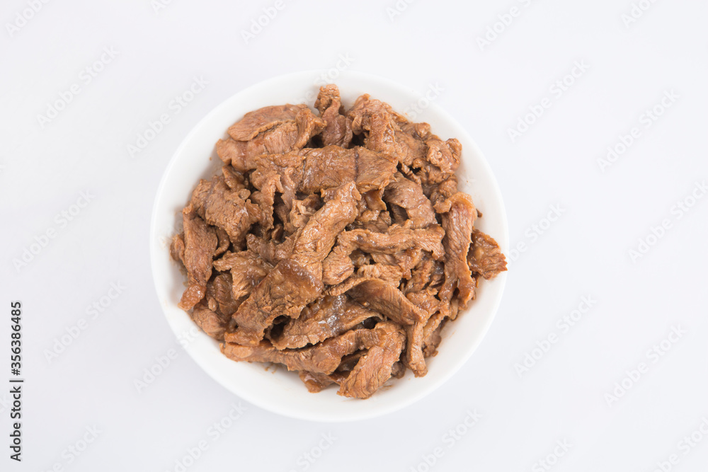 isolated close up flat lay top view shot of sliced beef fillet pieces in a white bowl on a white background isolated close up flat lay top view shot of sliced beef fillet pieces in a white bowl on a white background
