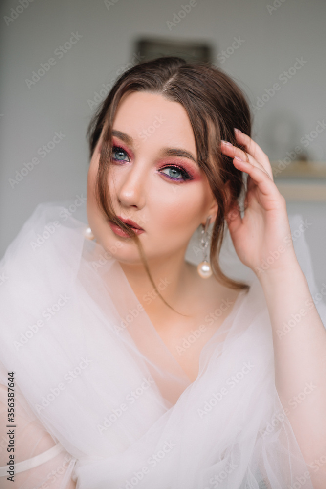 Beautiful model girl bride with bright makeup gently looks at the camera. Portrait Beautiful model girl bride with bright makeup gently looks at the camera. Portrait