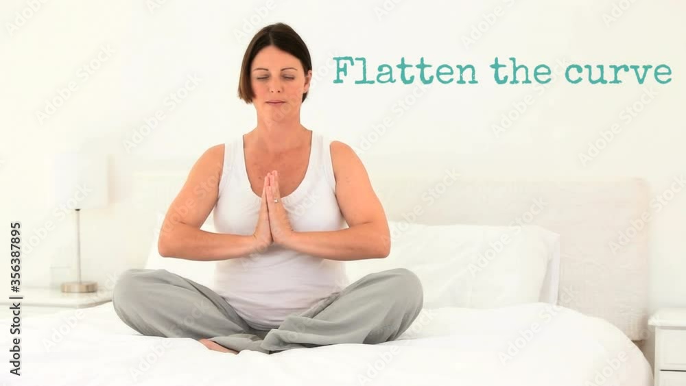 Caucasian woman doing yoga at home with words Flatten the curve during coronavirus pandemic Caucasian woman doing yoga at home with words Flatten the curve during coronavirus pandemic