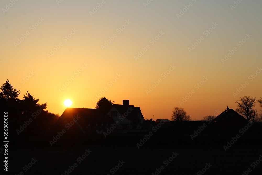 House silhouetted in the  sunrise