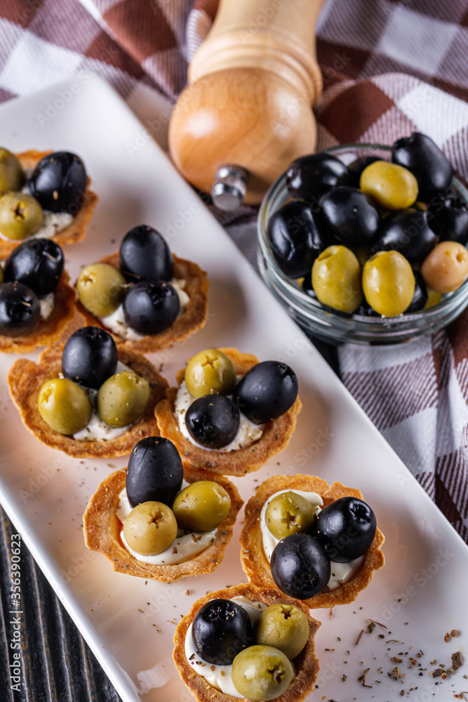 delicious snack tartlets on rustic wooden background