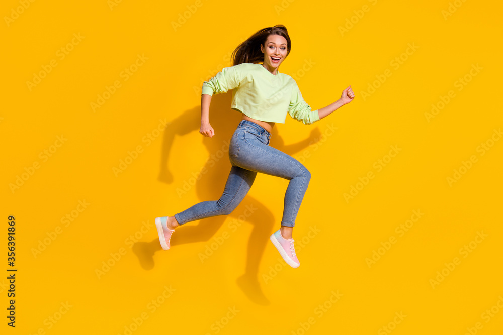 Full body profile side photo of cheerful enthusiastic girl jump run after season discount wear good look clothes gumshoes isolated over bright color background