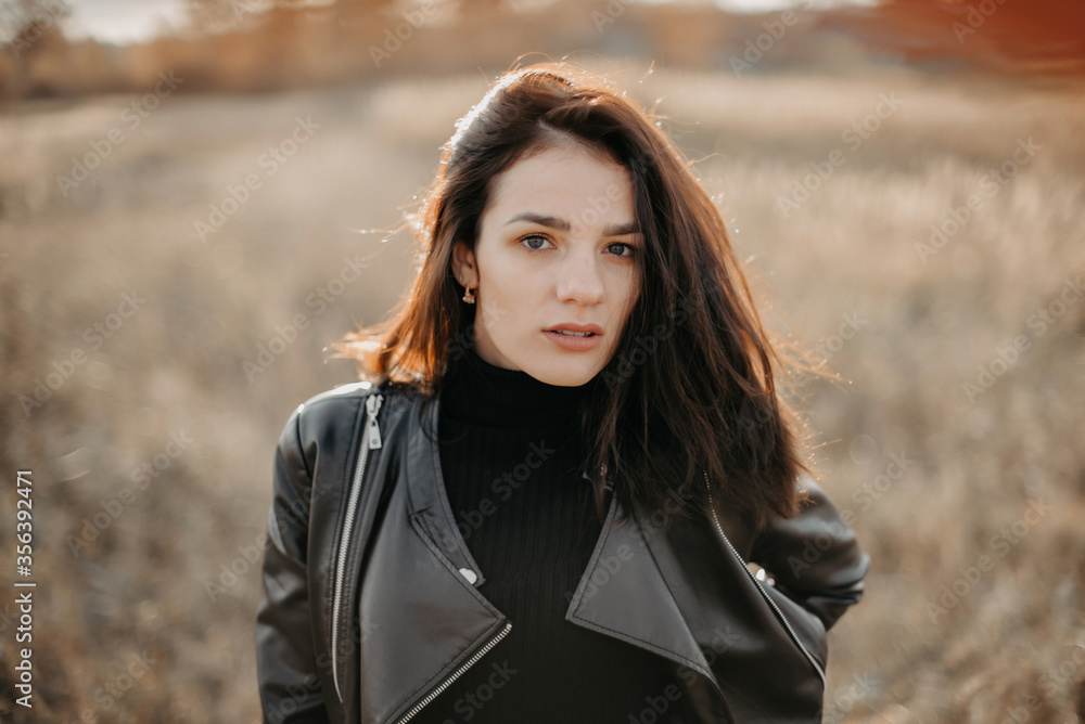 portrait of a fashionable young Caucasian brunette girl in a leather jacket portrait of a fashionable young Caucasian brunette girl in a leather jacket