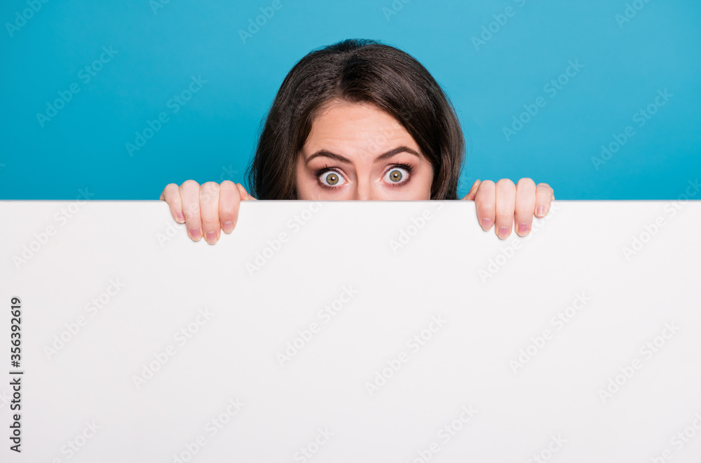 © deagreez - Closeup photo of pretty funny crazy lady hold hands empty advertisement banner peeking eyes hiding face tricky read novelty surprise placard isolated blue color background © deagreez - Closeup photo of pretty funny crazy lady hold hands empty advertisement banner peeking eyes hiding face tricky read novelty surprise placard isolated blue color background
