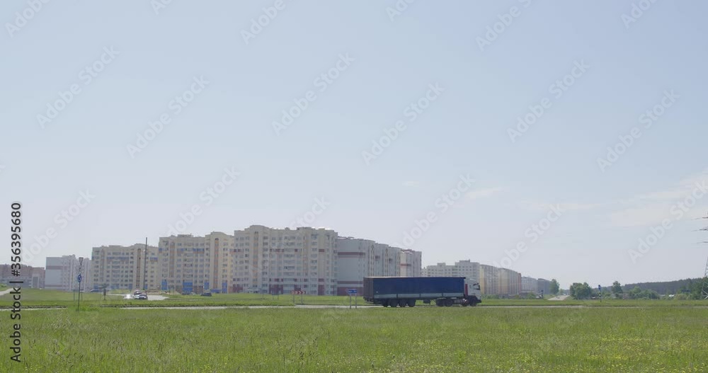 A road with cars on the outskirts of a city. A road with cars on the outskirts of a city.