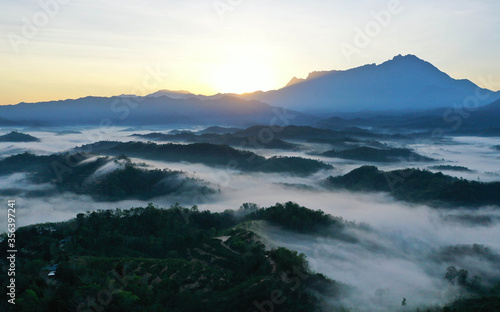 Scenery of Mount Kinabalu forest with low clouds on the morning from aerial scene. © Mohd Khairil
