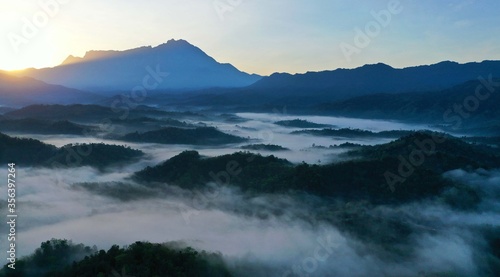 Scenery of Mount Kinabalu forest with low clouds on the morning from aerial scene. © Mohd Khairil