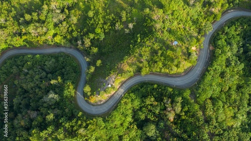 Aerial view of hilly region borneo showing forests, roads and slopes