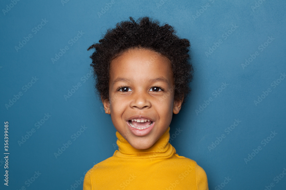 Surprised black kid boy on blue background Surprised black kid boy on blue background