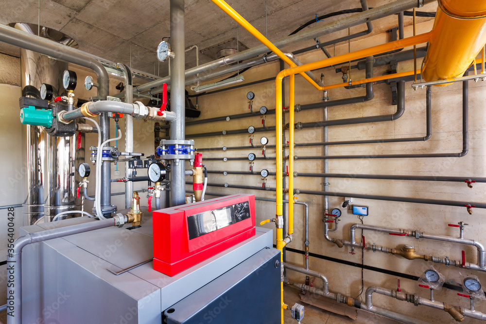 interior of a modern gas boiler room, with a water treatment system, many valves and sensors interior of a modern gas boiler room, with a water treatment system, many valves and sensors