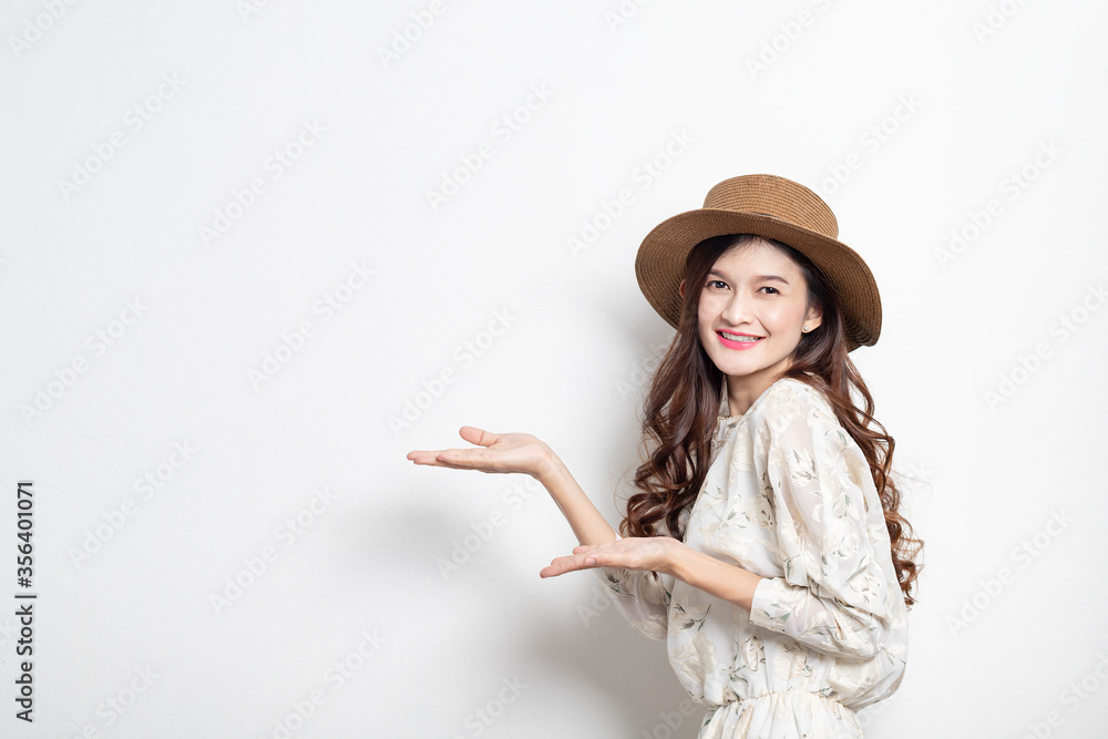 Portrait of a smiling asian woman presenter on white background, Asian woman pointing to the copy space, Beautiful thai girl. Portrait of a smiling asian woman presenter on white background, Asian woman pointing to the copy space, Beautiful thai girl.