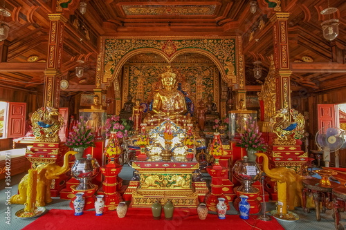 view of Golden Upagupta Buddha Statue on base in buddhist temple, Wat Ming Muang, Chiang Rai, northern of Thailand.